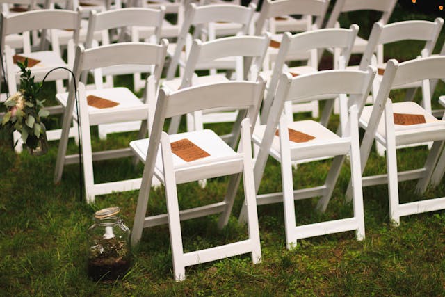 white-wooden-chairs-on-green-grass-field