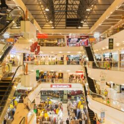 a-mall-filled-with-lots-of-people-and-escalators